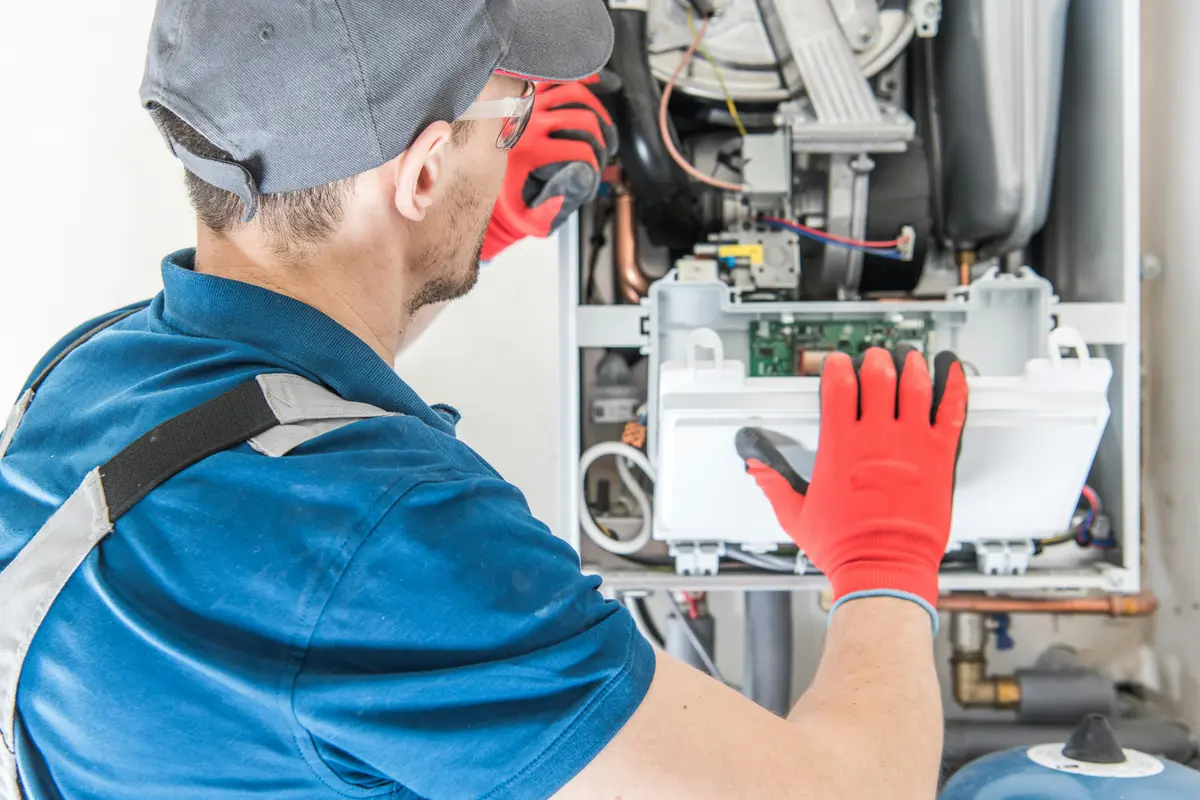 HVAC technician performing annual maintenance on a boiler in Calgary