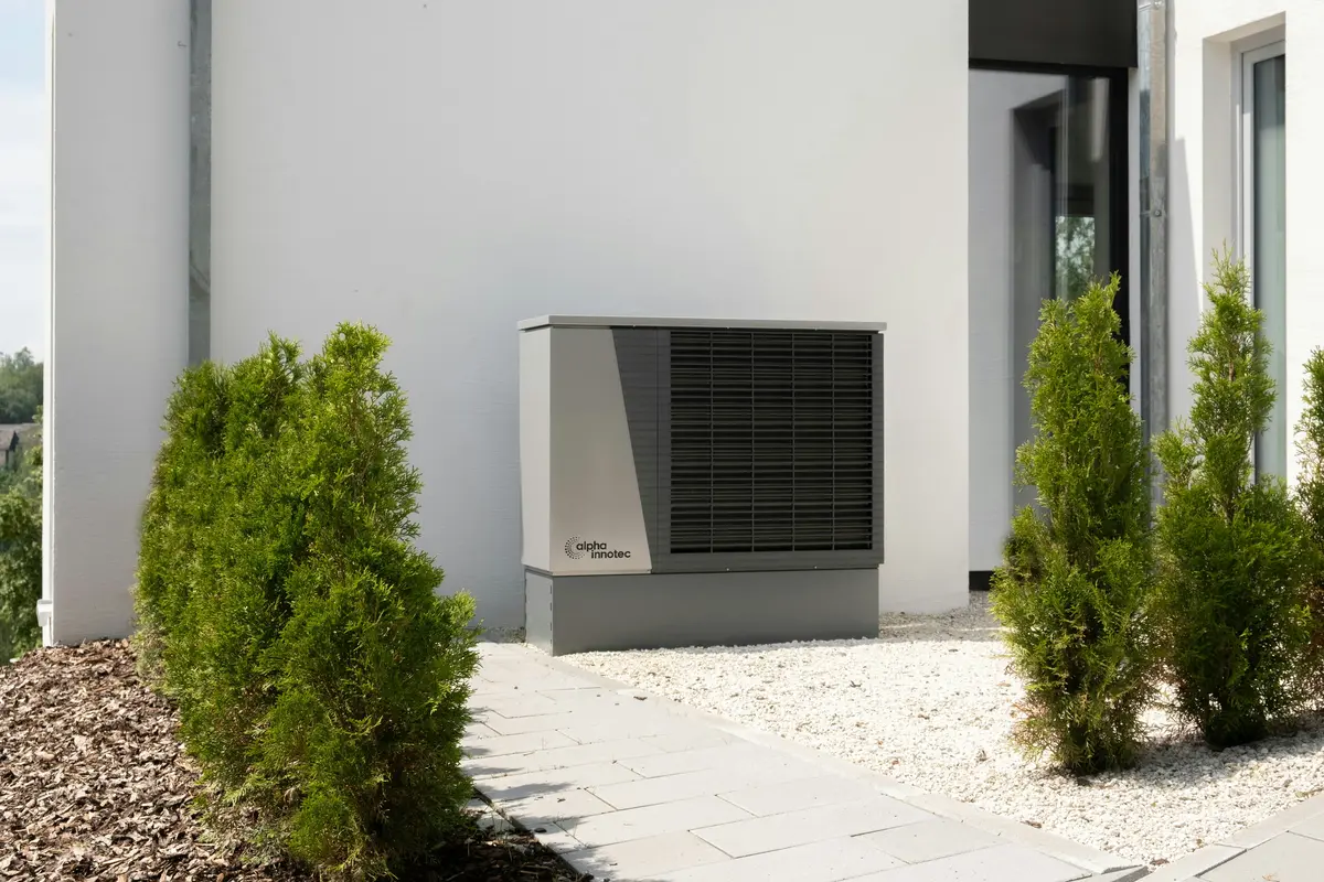 Cold-climate heat pump outdoor unit mounted on Calgary home exterior