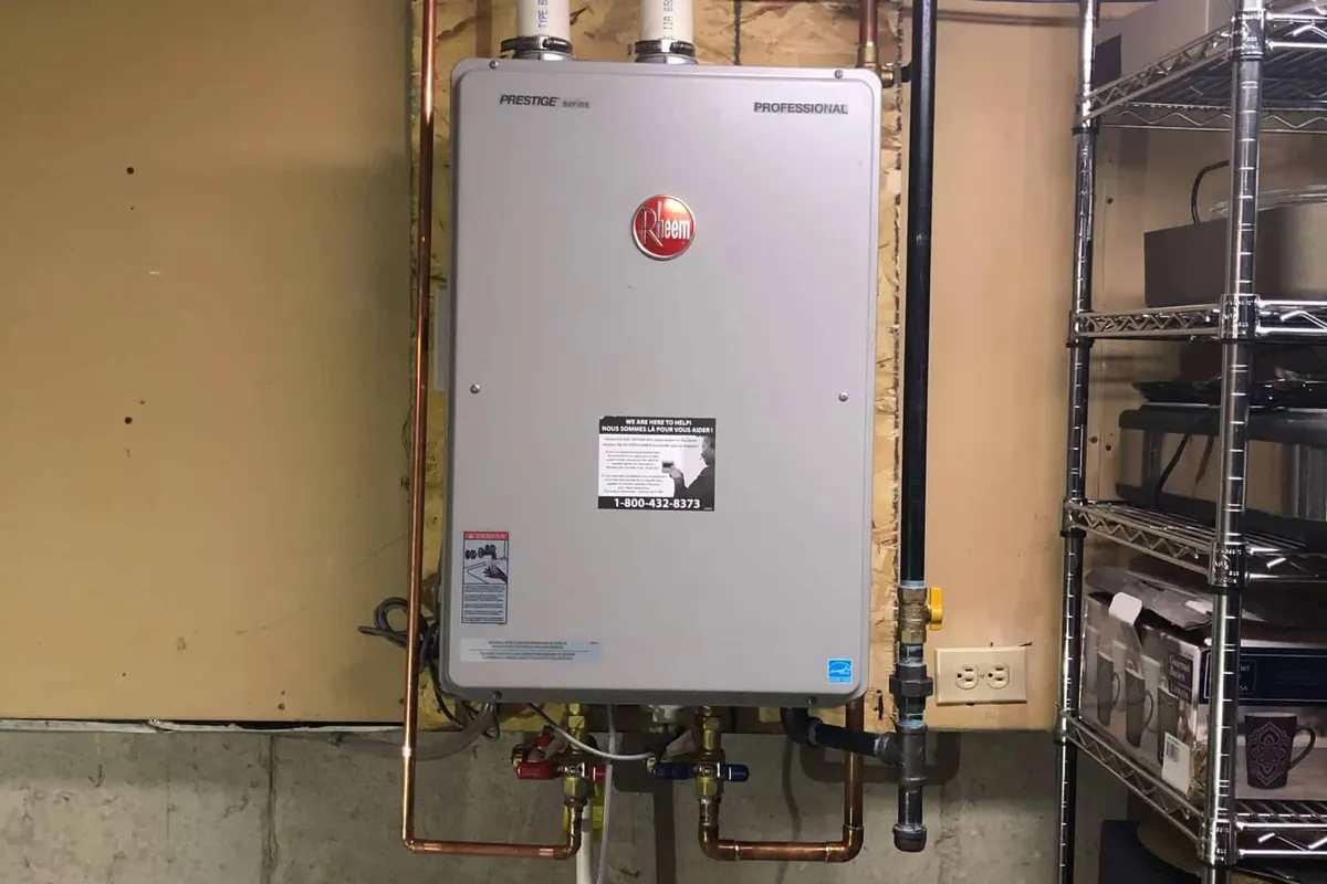 Rheem tankless water heater installed on a wall in a Calgary basement